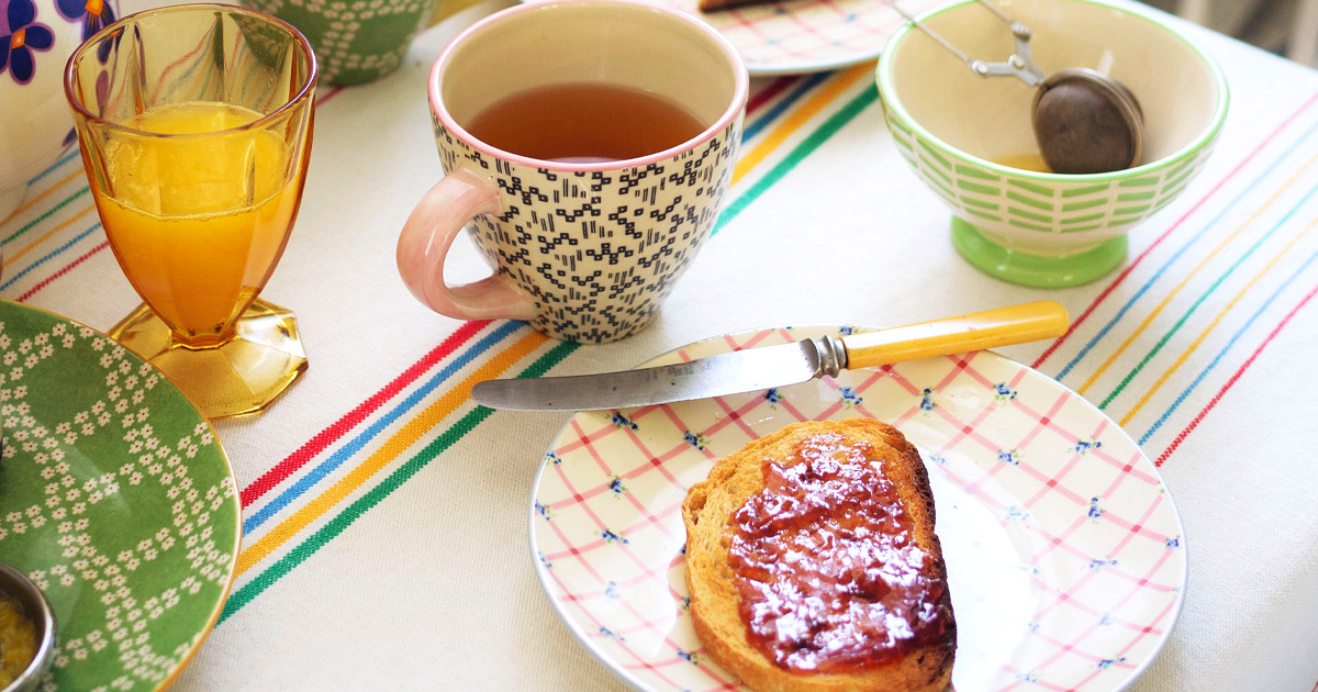 Table with jam, toast, and tea