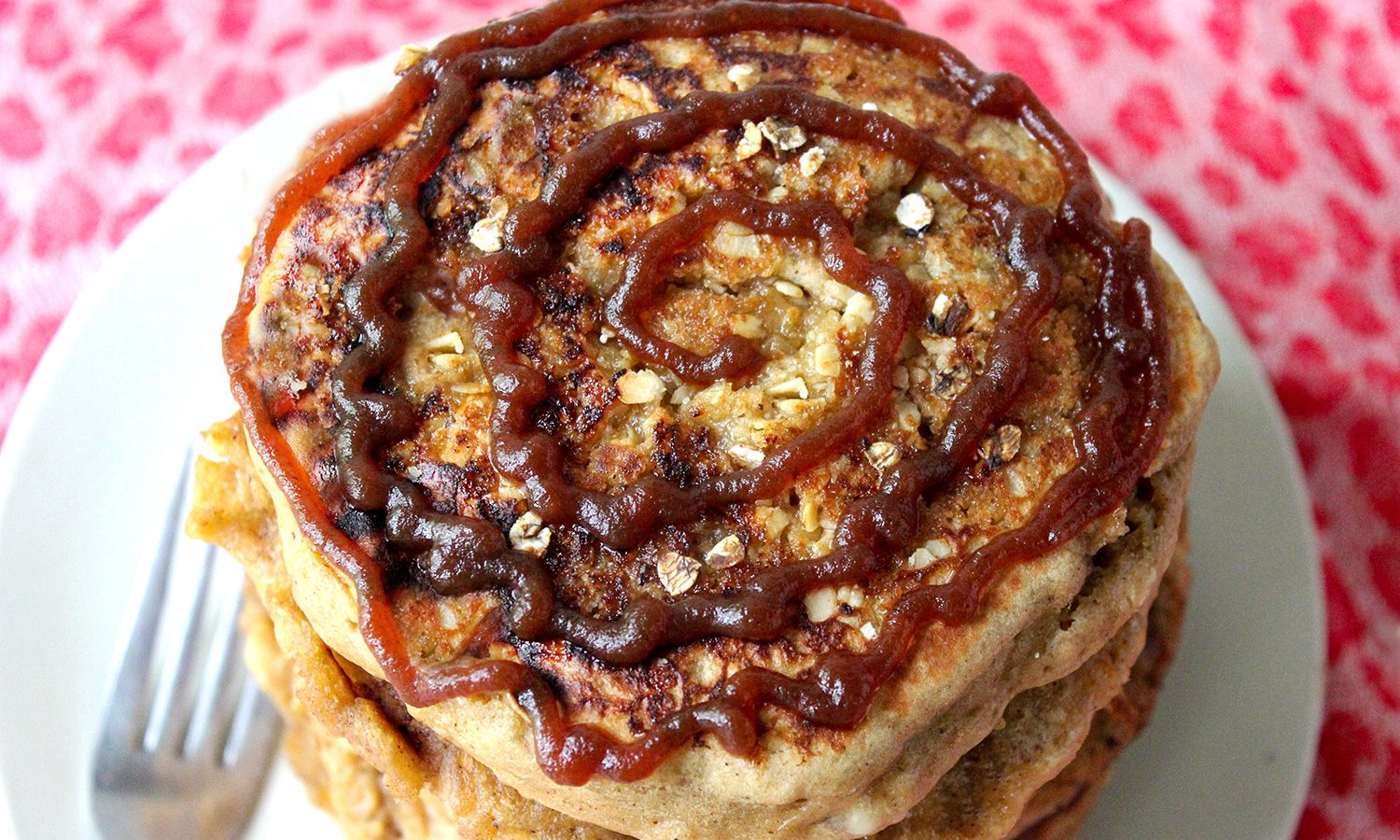 Spiced apple butter pancakes stack with a spiral of apple butter on top