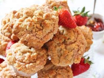 Stack of strawberry jam muffins with summer strawberries