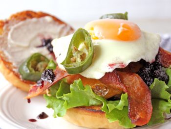 Burger and egg with blackberry jam, bacon, and jalapeno peppers