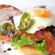 Burger and egg with blackberry jam, bacon, and jalapeno peppers