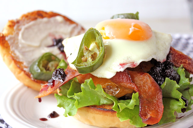 Burger and egg with blackberry jam, bacon, and jalapeno peppers