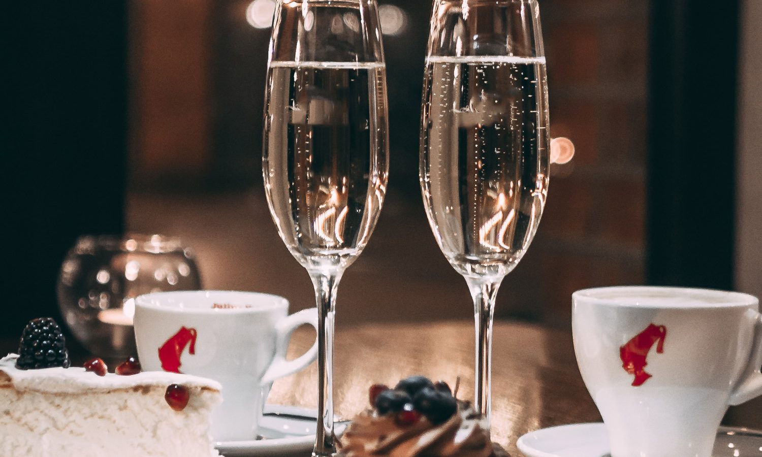 Two champagne glasses with desserts