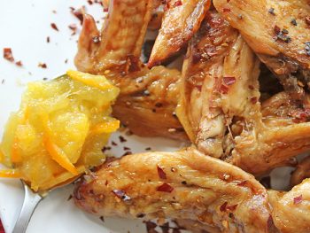 Orange Marmalade Chicken Wings plated with spoon of marmalade