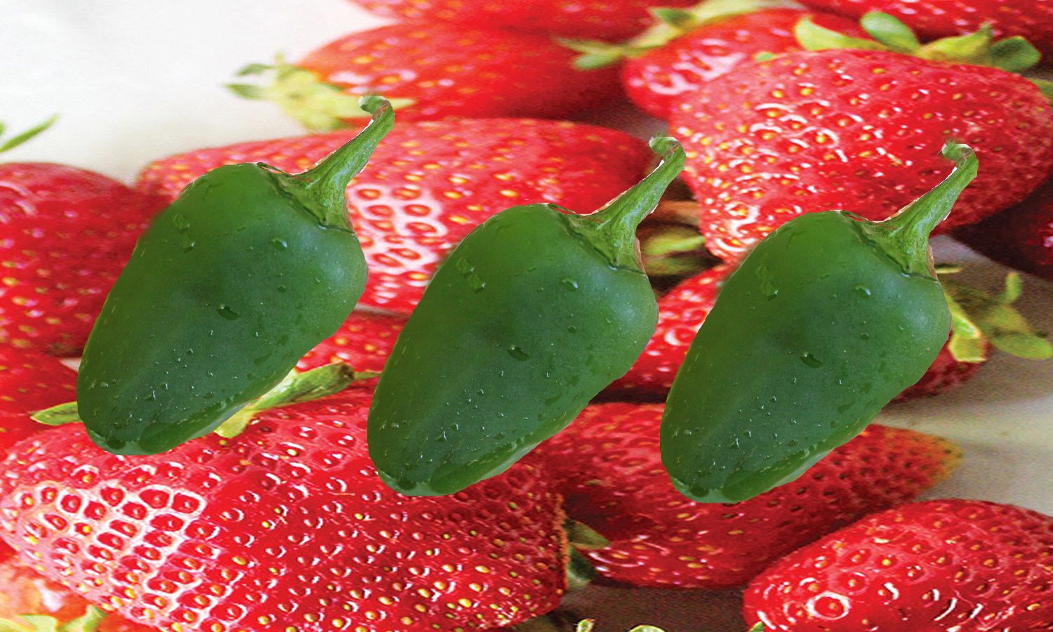 Jalapeno Peppers superimposed over fresh strawberries