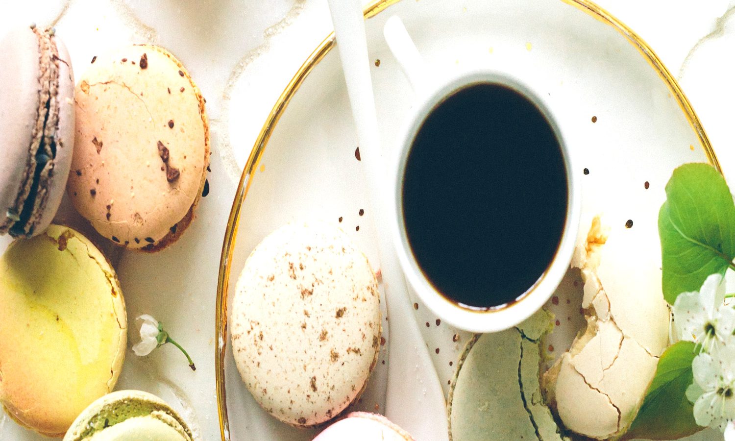 Tea cup with scattered pastel macrons